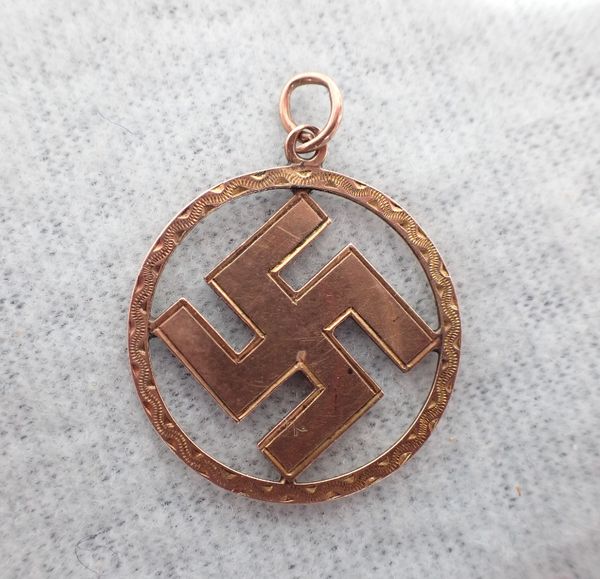 A 9 CT GOLD SWASTIKA PENDANT