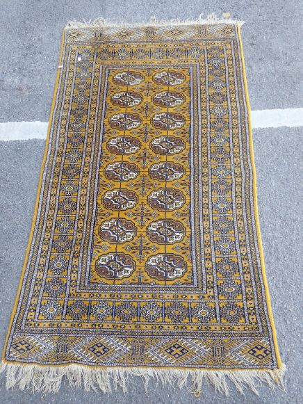 A YELLOW GROUND PERSIAN DESIGN RUG