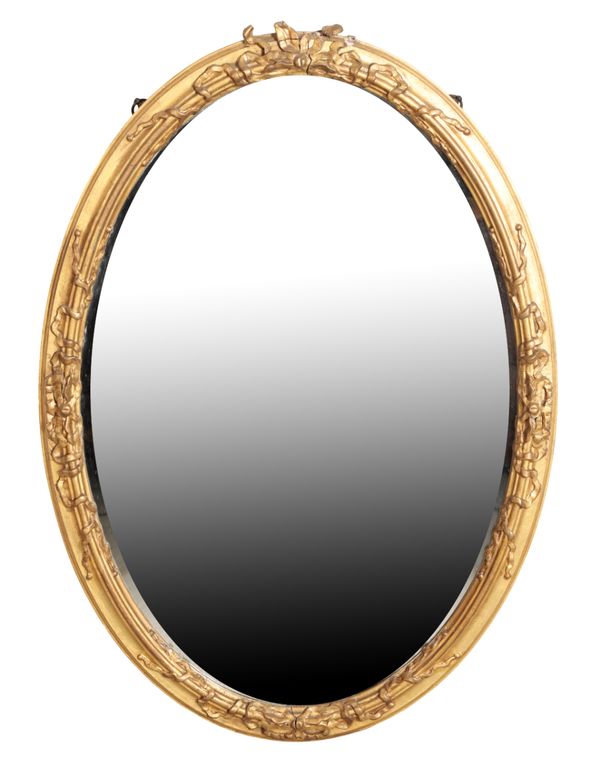 A GILTWOOD AND COMPOSITION FRAMED OVAL WALL MIRROR,