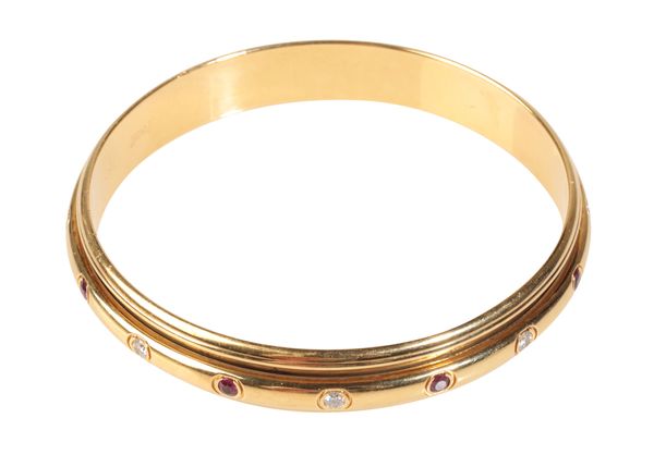 PIAGET; A YELLOW GOLD DIAMOND AND RUBY POSESSION BANGLE