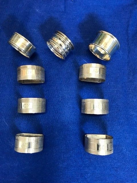 A COLLECTION OF NINE SILVER NAPKIN RINGS