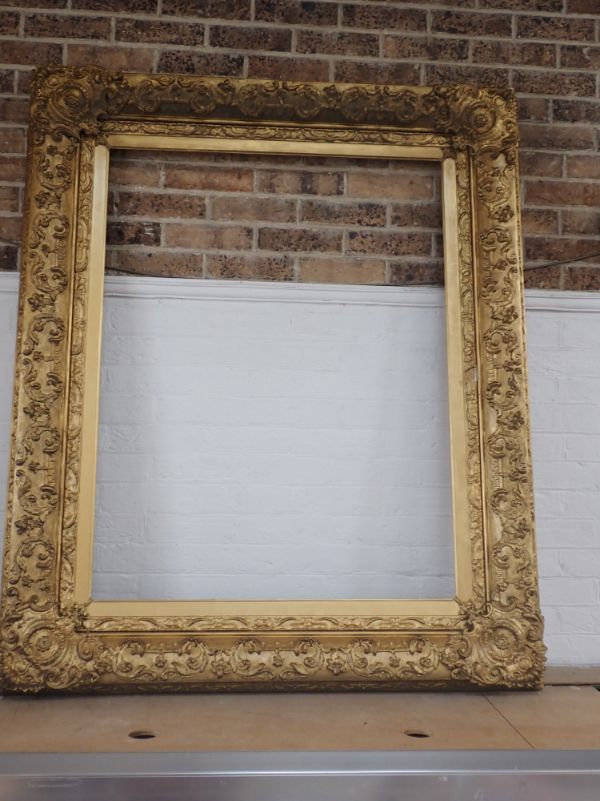 A LARGE 19TH CENTURY GILT GESSO PICTURE FRAME