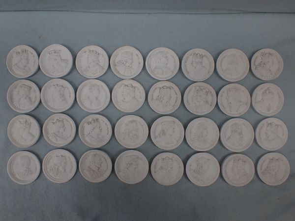 A COLLECTION OF 32 CAST PLASTER PLAQUES DEPICTING THE RULERS OF FRANCE