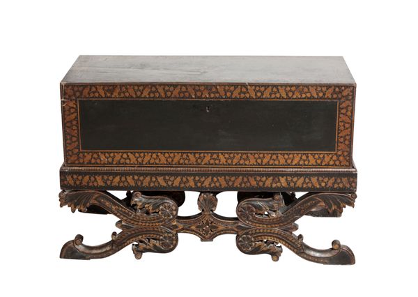 AN ANGLO-INDIAN BLACK AND GOLD LACQUERED COFFER ON STAND