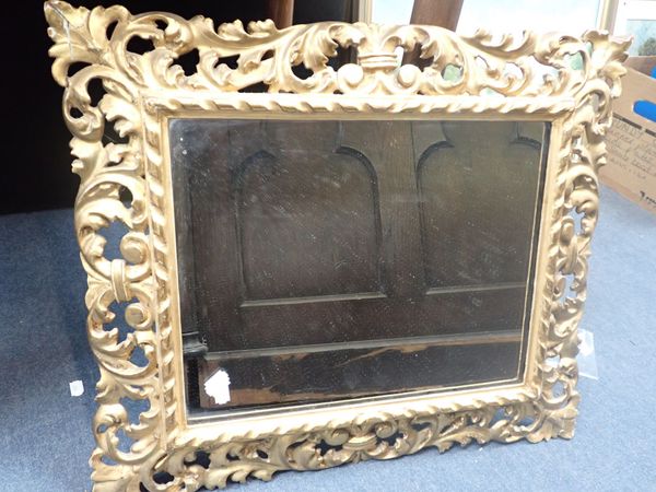 A FLORENTINE CARVED GILTWOOD MIRROR