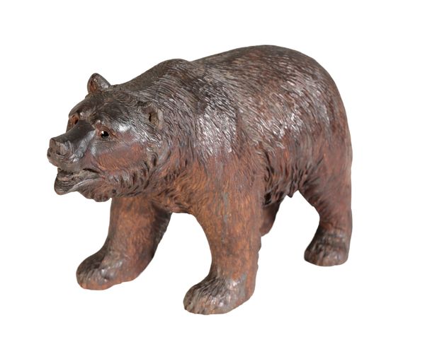 A 'BLACK FOREST' CARVED AND STAINED LINDEN WOOD MODEL OF A BEAR,