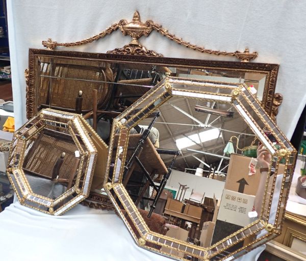 A GILT FRAMED WALL MIRROR WITH SWAGGED DECORATION