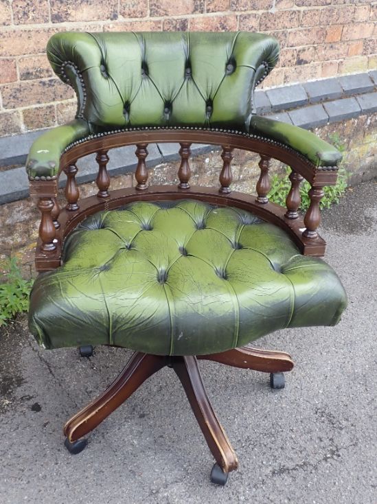 A SWIVEL DESK CHAIR, IN GREEN LEATHER