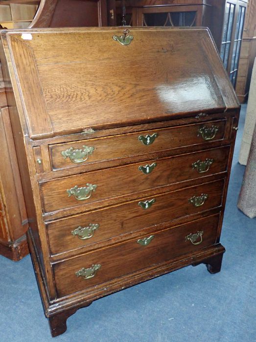 A GEORGE III STYLE OAK BUREAU OF SMALL PROPORTIONS