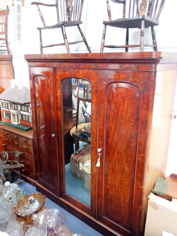 A MID 19TH CENTURY MAHOGANY TRIPLE WARDROBE