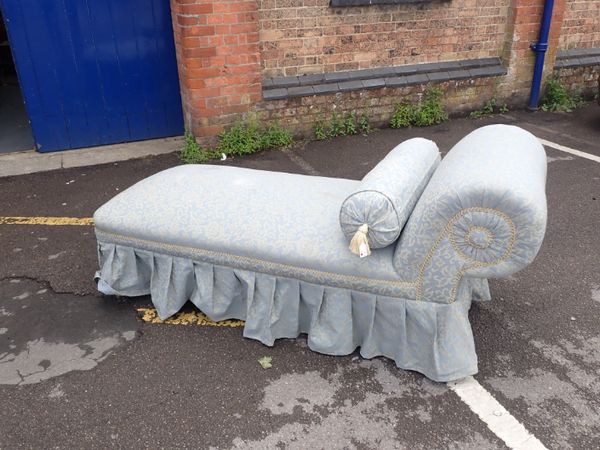 A VICTORIAN DAYBED, IN FIGURED BLUE UPHOLSTERY