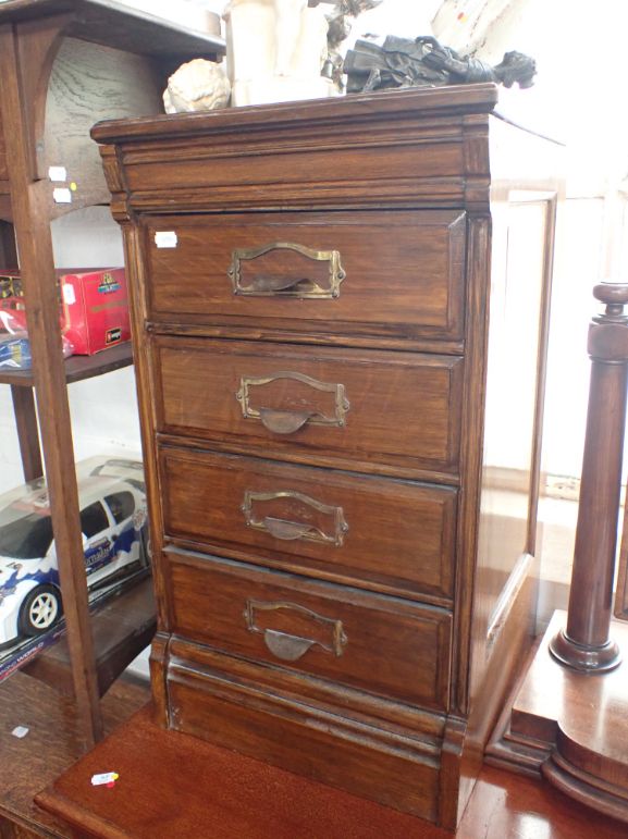 A SMALL EDWARDIAN OAK FILING CABINET