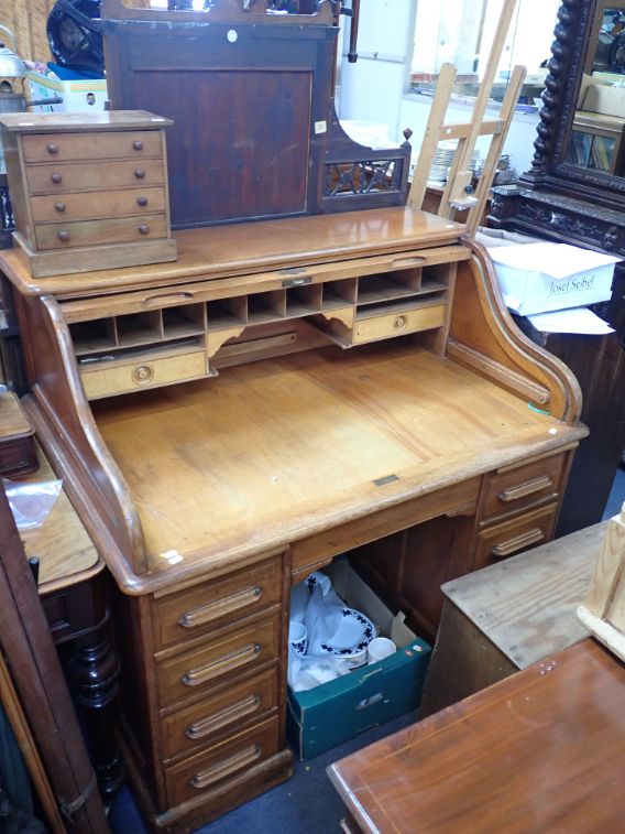 A GOLDEN OAK ROLL-TOP DESK