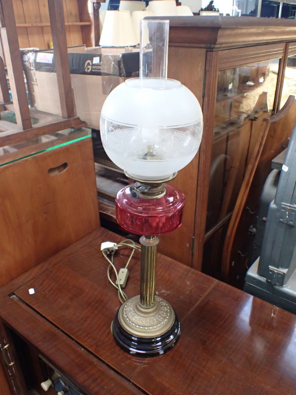 A VICTORIAN OIL LAMP WITH CRANBERRY GLASS FONT