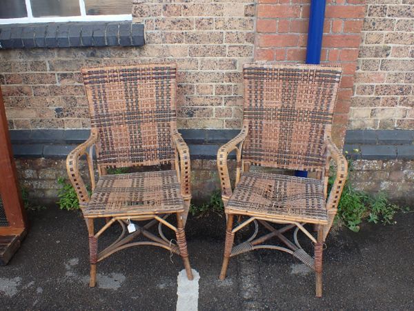 A PAIR OF EDWARDIAN RATTAN ARM CHAIRS BY MAPLE & CO