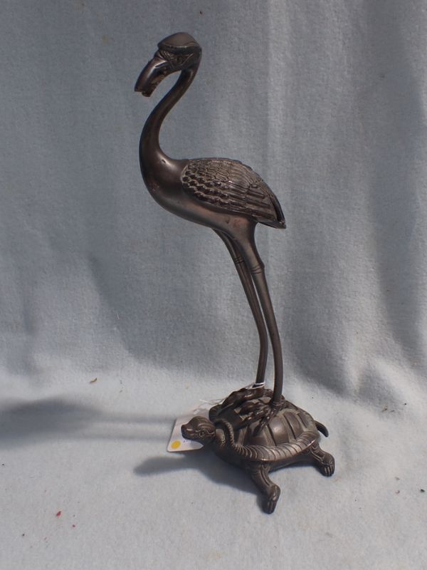 A  CAST BRONZE STORK STANDING ON A TORTOISE