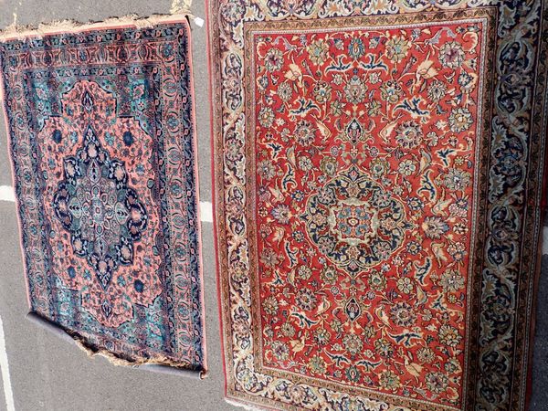 A RED GROUND PERSIAN RUG