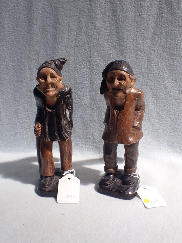 A PAIR OF BLACK FOREST TYPE CARVED WOODEN NUTCRACKERS