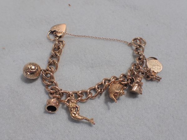 A 9CT GOLD CHARM BRACELET AND CHARMS