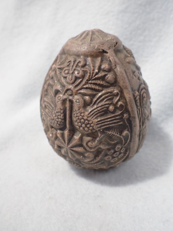 A MOULDED CLAY 'EGG' DEPICTING THE NATIVITY