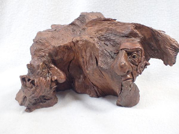 A WOOD AND COMPOSITION SCULPTURE OF TWO GROTESQUE HEADS