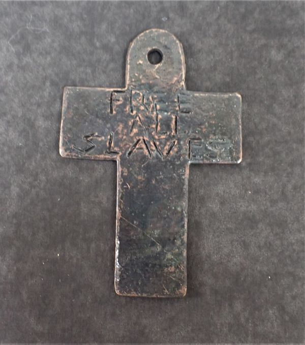 A TALISMANIC CROSS, CRUDELY  INSCRIBED; 'FREE ALL SLAVES'