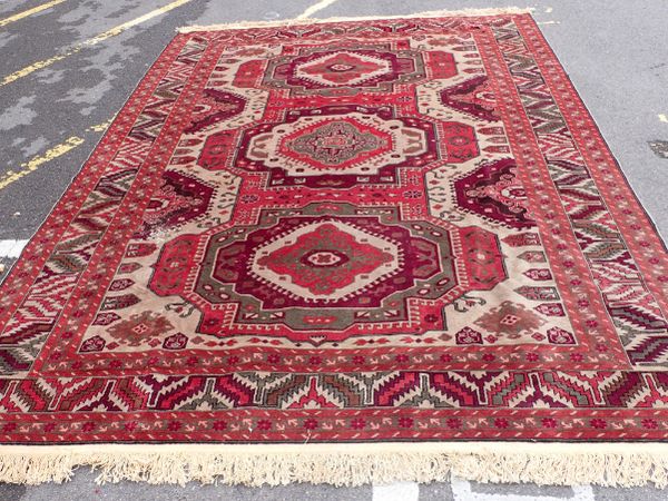 A RED GROUND 'KAYAN' RUG