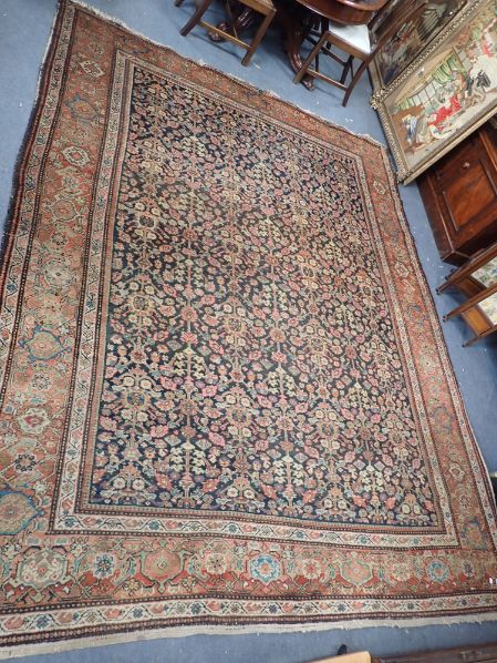 A LARGE BLUE GROUND PERSIAN DESIGN RUG