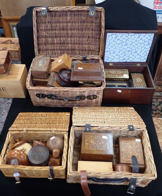 A COLLECTION OF WOODEN BOXES CONTAINED IN THREE WICKER BASKETS
