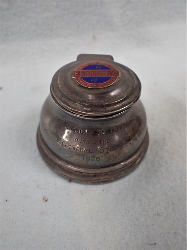 THE GENERAL STRIKE: A SILVER INKWELL, WITH ENAMELLED PLAQUE