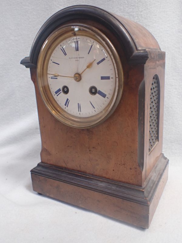 A WALNUT AND EBONISED CASED CLOCK