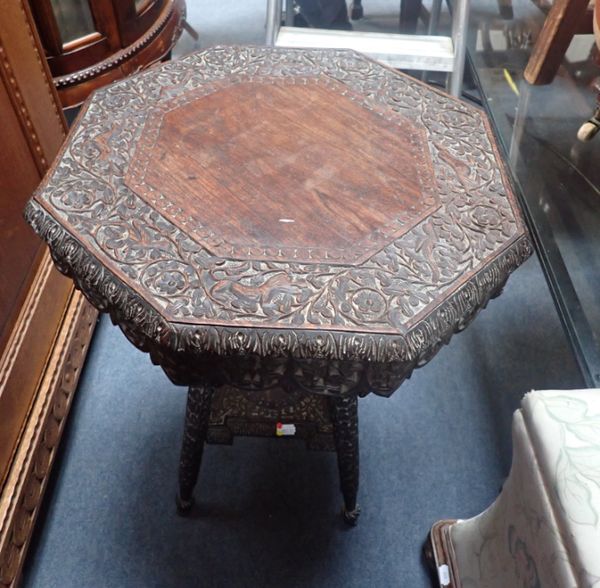 AN INDIAN CARVED HARDWOOD OCCASIONAL TABLE