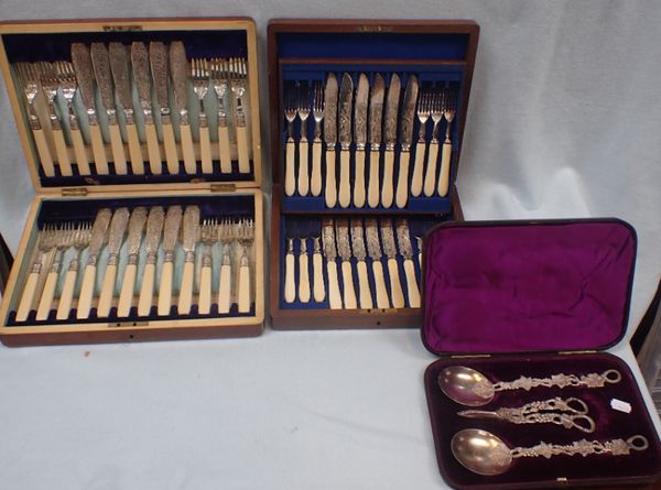 A CASED SET OF TWELVE SILVER-PLATED FISH EATERS