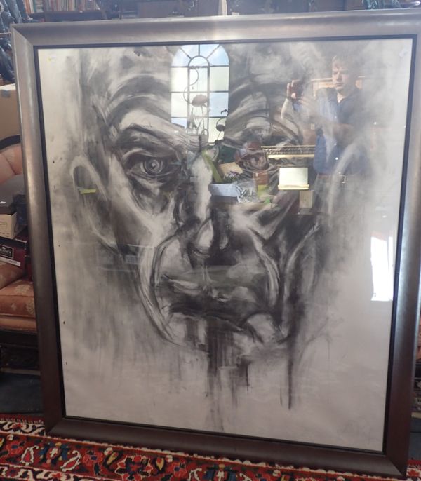 A LARGE SCALE CHARCOAL STUDY OF A MAN'S FACE