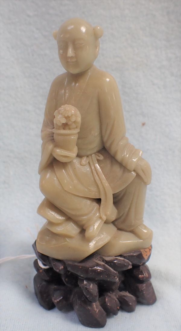 A CARVED SOAPSTONE FIGURE, 20TH CENTURY