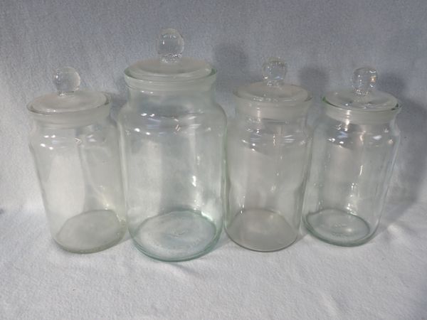 FOUR VINTAGE GLASS STORAGE JARS, WITH GLASS LIDS