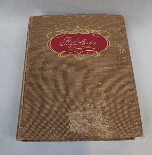 A POSTCARD ALBUM, DATED 1914, CONTAINING APPROXIMATELY 300 CARDS