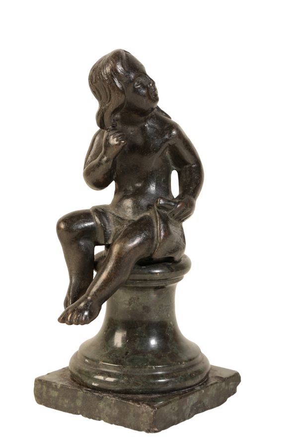 A BRONZE FIGURE OF A SEATED MAN