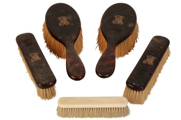 A SET OF FOUR TORTOISESHELL AND MONOGRAMMED GENTLEMANS DRESSING BRUSHES