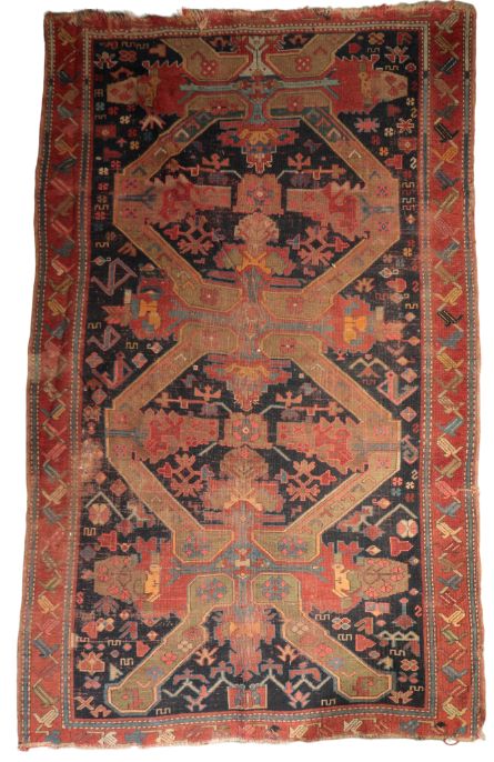 A DARK BLUE GROUND CAUCASIAN RUG