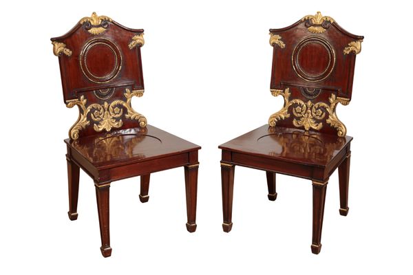 A PAIR OF MAHOGANY AND PARCEL-GILT HALL CHAIRS IN GEORGE II STYLE