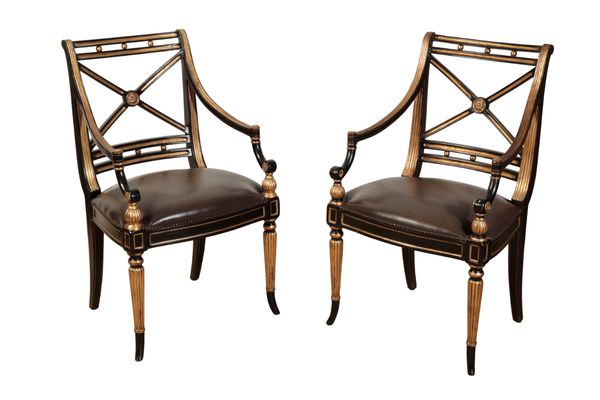 A PAIR OF REGENCY STYLE EBONISED AND GILTWOOD ELBOW CHAIRS