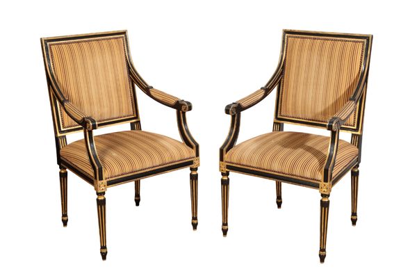 A PAIR OF REGENCY STYLE EBONISED AND PARCEL-GILT ARMCHAIRS