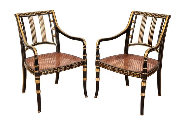 A PAIR OF EBONISED AND PARCEL-GILT ARMCHAIRS