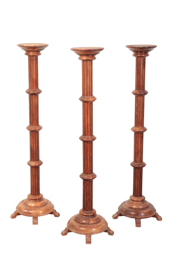 A SET OF THREE COLUMNAR TORCHERE