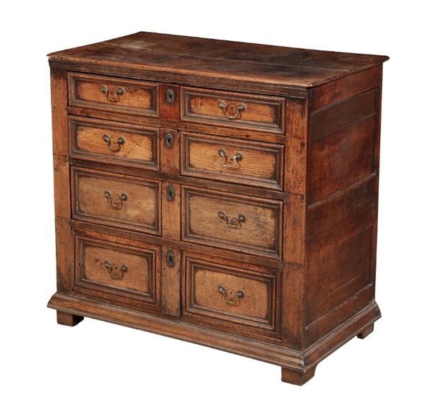 AN OAK CHEST OF DRAWERS