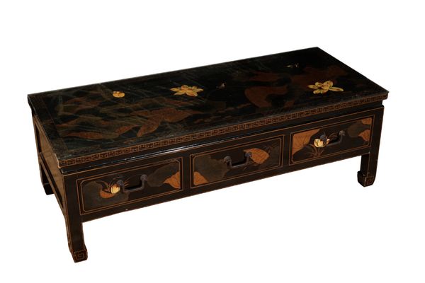 A BLACK LACQUERED COFFEE TABLE