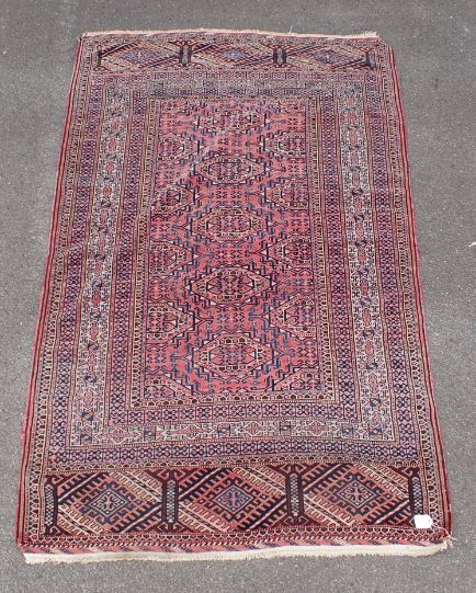 A ROSE GROUND PERSIAN DESIGN RUG