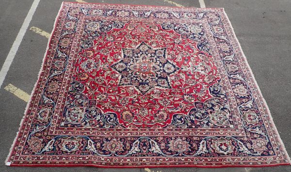 A LARGE RED GROUND PERSIAN DESIGN RUG