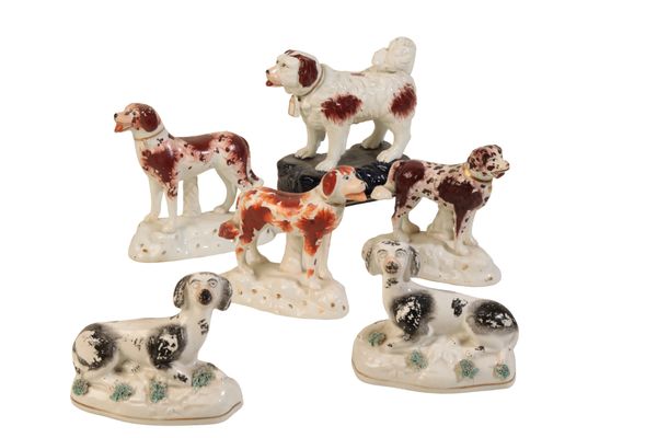 A PAIR OF STAFFORDSHIRE FIGURES OF RECUMBENT SPORTING DOGS,